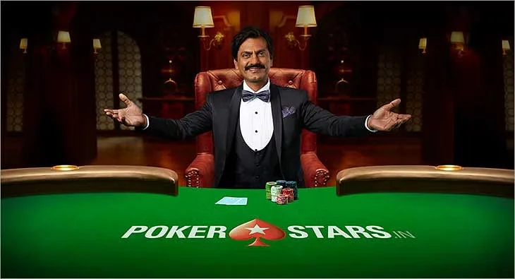 A promotional image for PokerStars IN showing a man in a tuxedo sitting at a poker table